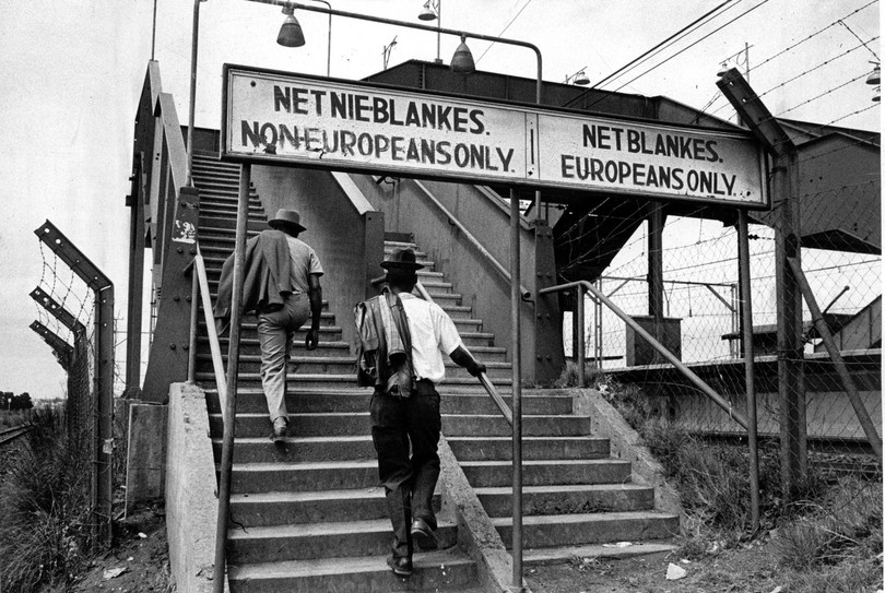 A segregated bridge at Pretoria railway station, South Africa, 1960s, photograph by Ernest Cole (1940–1990). The photo shows how South Africa’s apartheid system of formalized racial segregation, in which White South Africans had voting rights and non-White South Africans did not, meant segregating people even when they were crossing railway bridges to prevent any intermingling of the races.