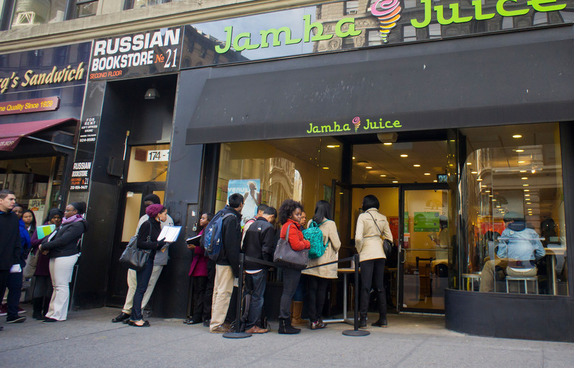 Job seekers line up to get a job at a Jamba Juice. As unemployment increases, open positions will attract more applicants, resulting in longer periods of unemployment for those without a job.