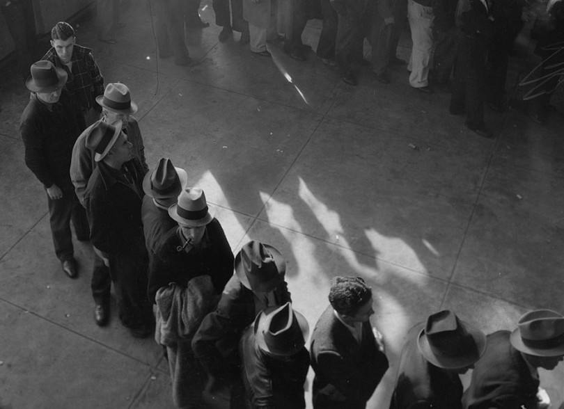 Line of men in San Francisco, California, waiting to register for unemployment benefits in January 1938, on one of the first days they were made available in that state.