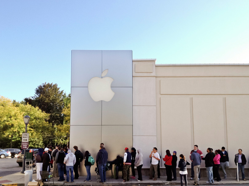 Buyers line up outside an Apple store to purchase the latest iPhone.